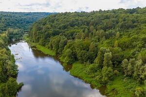 Breathtaking Landscape A Beautiful River Flows Through Charming Air and Lush Trees, Creating a Serene and Picturesque Natural Haven for All to Enjoy photo