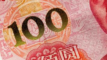 Close up of a 100 yuan banknote highlighting intricate Chinese patterns, often used in discussions about Chinas economy and on Chinese New Year photo