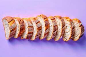 Sliced artisan bread arranged elegantly on a blue to purple gradient background, highlighting the texture and crust photo