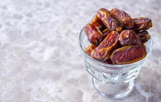 Dried date fruits on marble table photo