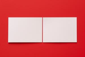 Blank two white business card on red background. Mockup business card. Top view. Copy space. photo