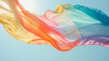 Vibrant pastel silk fabric flowing in the breeze against a clear blue sky, suggesting themes of freedom, creativity, and LGBTQ Pride celebrations photo