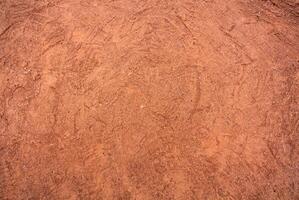 Red Sandy Surface Imprinted with Shoe Tracks, Texture Background photo