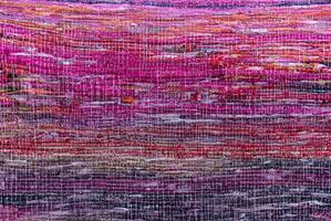 Cloth, typically produced by weaving or knitting textile fibers. Background and texture red old fabric. Closeup photo