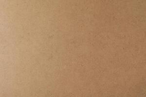 Horizontal Kraft Paper Texture Sheet on Cardboard Brown Background photo