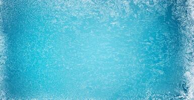 Frost Patterns on Frozen Winter Window, Symbolizing Christmas Wonder. Ideal Christmas or New Year Background. photo