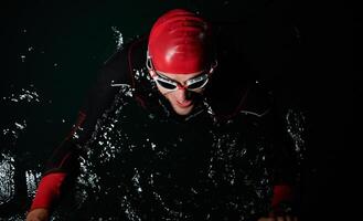 A triathlete finds serene rejuvenation in a lake, basking in the tranquility of the water after an intense training session photo