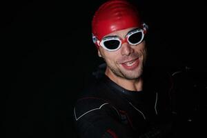 A triathlete finds serene rejuvenation in a lake, basking in the tranquility of the water after an intense training session photo