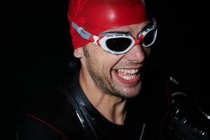 A triathlete finds serene rejuvenation in a lake, basking in the tranquility of the water after an intense training session photo