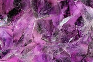 Close-up View of Raw Amethyst Quartz Crystals, Detailed Macro Shot of Purple Crystal Stone Surface photo