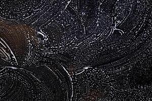 White Foam Texture of Detergent on Black Background photo