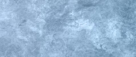 Winter-themed Abstract Background with Text or Image Space, Highlighted Blue Concrete Wall Texture, and Cloudy Distressed White Painting. photo