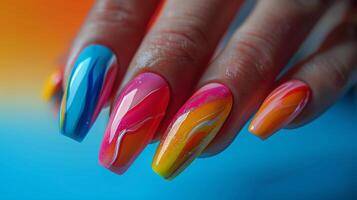 Womans Hand With Orange and Black Nail Polish photo