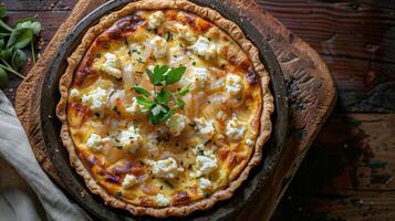 a whole quiche with a crumbly, buttery crust and a savory filling of caramelized onions and goat cheese photo