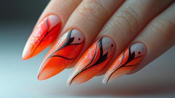 Womans Hand With Orange and Black Nail Polish photo