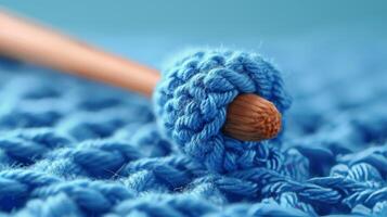 Close Up of Blue Crochet With Wooden Handle photo