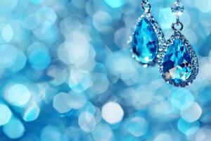 Jewelry, earrings on blue bokeh background. photo