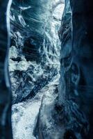 Beautiful ice formations in vatnajokull crevasse, massive blue icy rocks of melting frozen structure. Global warming affecting icelandic glaciers and icebergs, destroying ice caves. photo