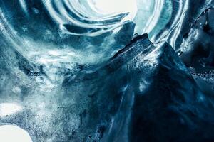 Massive ice blocks inside crevasse, vatnajokull glacier with transparent cracked texture in iceland. Iceberg rocks slowly melting in ice caves, covered frost texture in nordic landscape. photo