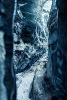 Ice rocks melting in iceland, global warming concept. Icy blocks with cracked transparent structure inside vatnajokull glacier crevasse, icelandic landscape in frosty ice caves. photo