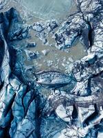 Aerial view of magnificent Vatnajokull ice blocks in Iceland and massive icebergs in arctic countryside scenery. Icy cold lake and snowy peaks with blue glaciers and frigid rocks. photo
