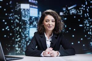 Woman night host reading headlines from media papers, presenting exclusive information to viewers on tv program. Presenter journalist reporting latest events with details, broadcast live. photo
