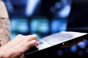 Close up of mechanic doing infrastructure servicing in blockchain technology high tech workplace using laptop. Skilled professional running operations in cryptocurrency mining farm photo