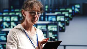 Octogenarian developer in high tech space equipped to handle modern computing requirements, doing regular upgrades to server rigs, increasing processing power and storage capacity to prevent defects photo