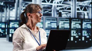 Adept computer scientist looking around cutting edge data center, preparing to start comission on defective high tech server mainframes in order to ensure secure operations photo