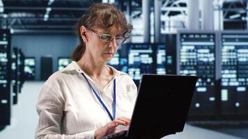 Knowledgeable supervisor looking around advanced data center, preparing to start comission on damaged high tech blade servers in order to ensure optimal operations photo