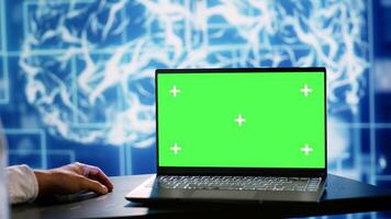 Computer scientist using green screen laptop to implement artificial intelligence parallel processing. Manager overseeing chroma key device enabling AI systems to do machine learning inference photo