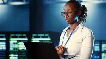 Woman walking through high tech facility server rows providing computing resources for different workloads. Admin reviewing data center supercomputers tasked with solving complex operations, close up photo