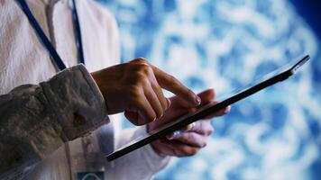 Licensed employee using tablet to maintenance artificial intelligence neural networks made up of interconnected nodes. Dilligent worker upgrades AI system processing information, close up photo