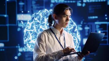 Qualified IT consultant in data center uses artificial intelligence computing simulating human brain thought processes. Licensed professional works on laptop with AI machine learning algorithms photo