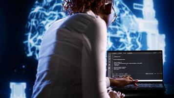 Proactive IT consultant writing artificial intelligence script code in startup workspace on tablet terminal. Competent inspector doing maintenance work in high tech facility updating AI systems photo