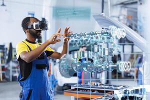 Technician in repair shop using augmented reality holograms to check car performance parameters during maintenance. Licensed garage employee using futuristic vr headset to examine damaged vehicle photo
