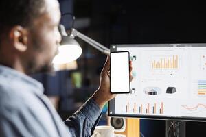 Male researcher ready to create new financial statement for the accounting staff, examining white screen on smartphone. Employee presenting blank layout while working with company statistics. photo