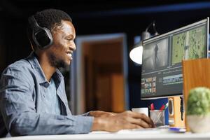 editor working on creating special effects on clips, adjusting movie footage with color wheel and motion graphics at desk. Content creator editing montage segments for post production agency. photo