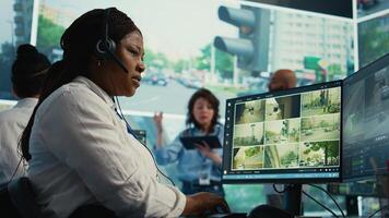 African american operator gathers gps coordinates and data for the government database, monitoring cars in traffic via surveillance CCTV security systems. Real time radar recordings. Camera B. photo