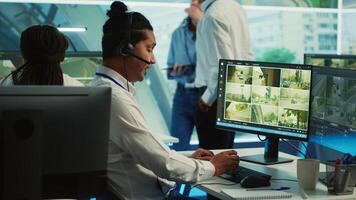 Indian employee communicating satellite map directions in observation room, monitoring traffic around the city via CCTV security system. Young man works with surveillance data. Camera A. photo