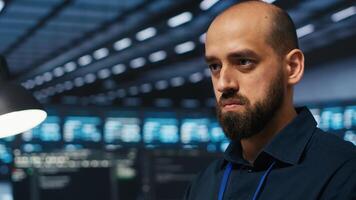 Close up on programmer in server farm safeguarding data from intruding hackers. Developer protecting server rows against unauthorized access, securing system from ransomware attacks photo