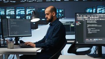 Computer scientist programming in high tech facility with server rows providing computing resources for different workloads. IT programmer overseeing supercomputers tasked with solving data operations photo
