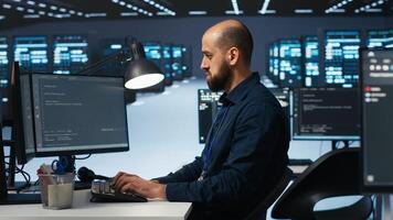 IT specialist in server farm ensuring valuable data remains shielded from potential threats, safeguarding against unauthorized access and vulnerabilities, securing system from virus attacks photo
