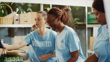 Multiracial team that fights hunger distributes free meals to the poor while helping and supporting the homeless. Warm meals are provided by volunteers in effort to combat hunger and poverty. photo