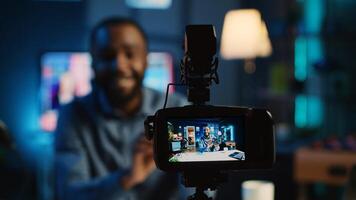 Close up on professional camera capturing content creator filming review of V mount battery unpacking to audience. Recording device filming influencer showing charging device to viewership photo
