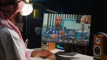 Arabic team leader holding online conference meeting with remotely working subalterns, checking on task progress. Middle Eastern business executive discussing with workers during call photo