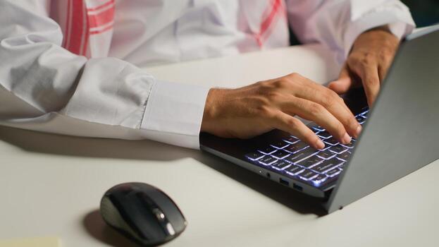 Close up shot of businessman using laptop and mouse in office to solve various work tasks. Employee typing on notepad keyboard in order to deliver finalized project paperwork to management photo