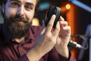 Close up shot of happy influencer endorsing wireless mouse from sponsor, rating it highly. Friendly media star advertising office computer peripheral from partnering brand to viewers on social media photo