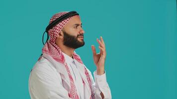 Middle eastern guy being contemplative and thinking about new innovative ideas, being interested in a subject and trying to find answer. Young person being thoughtful and uncertain in studio. photo