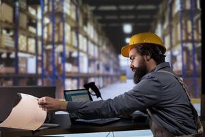 Inventory engineer uses barcode reader to verify products and orders, working on distribution and shipment. Customs compliance employee scanning merchandise tags and labels at warehouse. photo